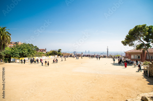 Barcelona, Spain - April, 2019: Park Guell Colorful Wide View of Buildings with Tourists with tourist view on Barcelona