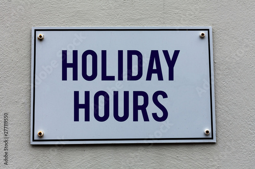 Conceptual hand writing showing Holiday Hours. Concept meaning employee receives twice their normal pay for all hours © Artur