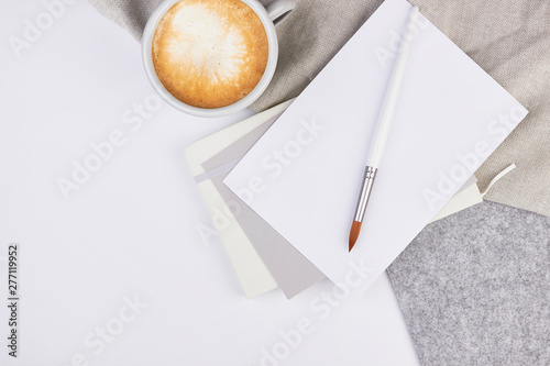 light grey flatlay top view coffee notbook flatlay wedding invitation feminine minimalistic work business art brush jewelry silver light grey photo