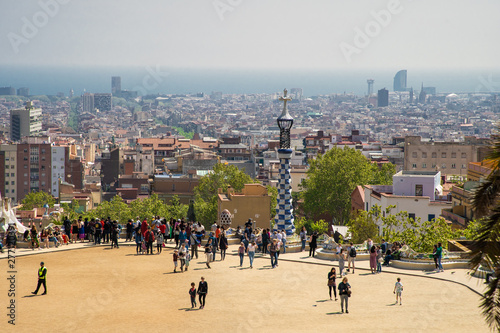 BARCELONA, SPAIN - April, 2019: View of the famous bench - serpentine seating on the main terrace of Park Guell, architectural landmark designed by the famous architect Antonio Gaudi.