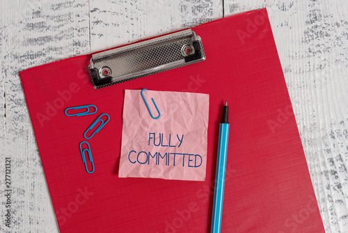 Writing note showing Fully Committed. Business concept for Extremely agreed to do something in life definitely Colored clipboard crushed sticky note clip marker old wooden background photo