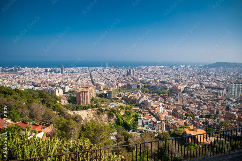 Barcelona, Spain - April, 2019: View of Barcelona city and costline in spring from the Bunkers in Carmel neighborhood. Few building stand out like sagrada familia and Agbar tower