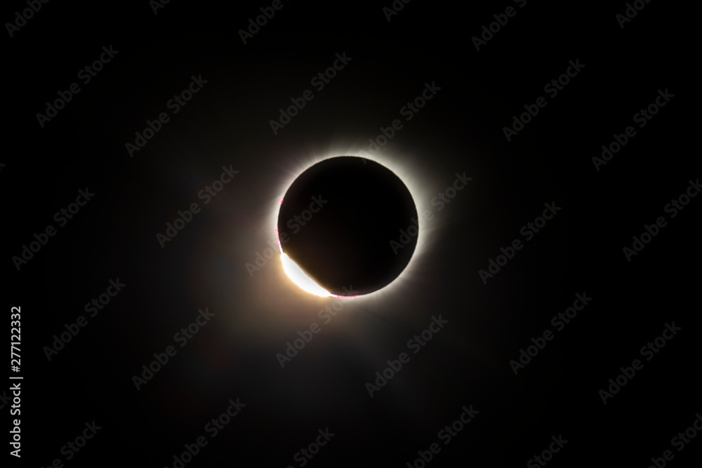 The Baily's beads effect and Diamond Ring effect during Total Solar Eclipse Chile 2019, amazing view of the Sun covered by the Moon during totality phase while the last sunbeams pass the Moon craters The Baily's beads effect and Diamond Ring effect during Total Solar Eclipse Chile 2019, amazing view of the Sun covered by the Moon during totality phase while the last sunbeams pass the Moon craters