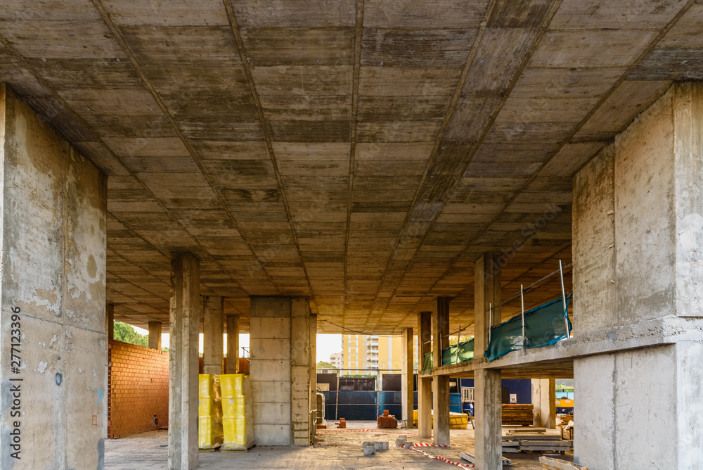 Valencia, Spain - July 3, 2019: Interior of a building under construction, with its cement walls and foundations in sight.