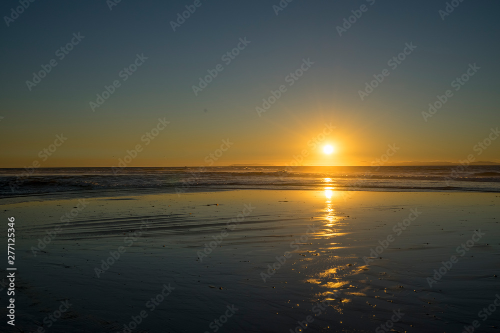 Sunset over ocean with reflection at Newport Beach, CA