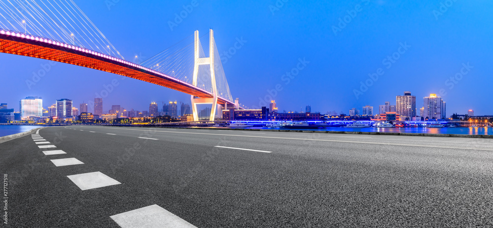 Shanghai Nanpu bridge and asphalt road scenery at night,China