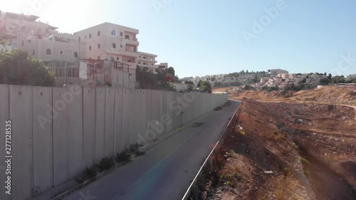 Flying close to security wall in Jerusalem Drone flight view of east Jerusalem security wall divide between Israeli and Arab neighborhood  Anata and pisgat zeev, israel photo