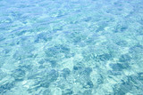 Close-up view of a transparent turquoise sea water that forms a natural texture, Emerald Coast, Sardinia, Italy.