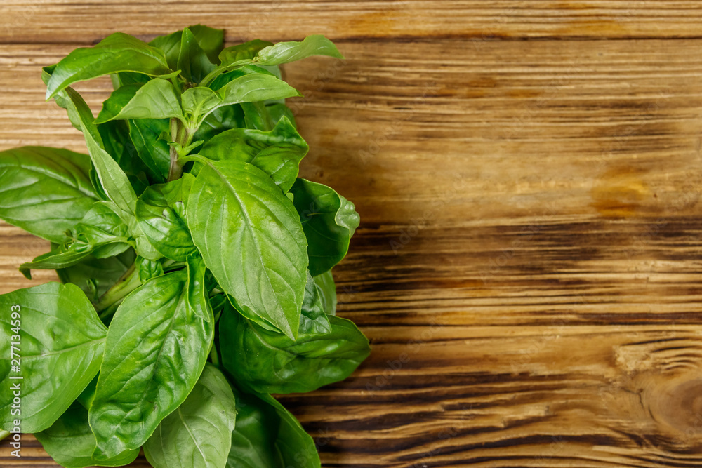 Green basil on a wooden table