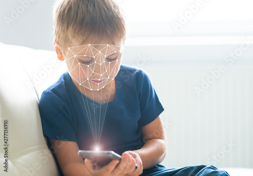 Obraz na plátně Kid using face id recognition