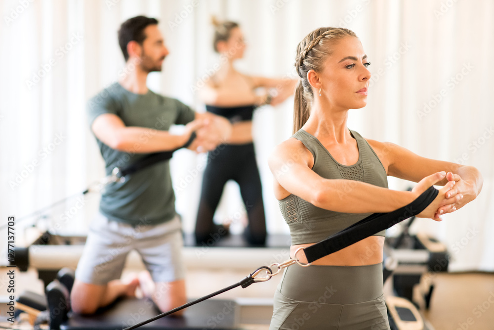 People exercising torso rotation at gym People exercising torso rotation at gym
