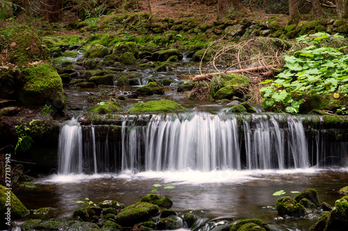 Water cascading over a rocky shelf in a river