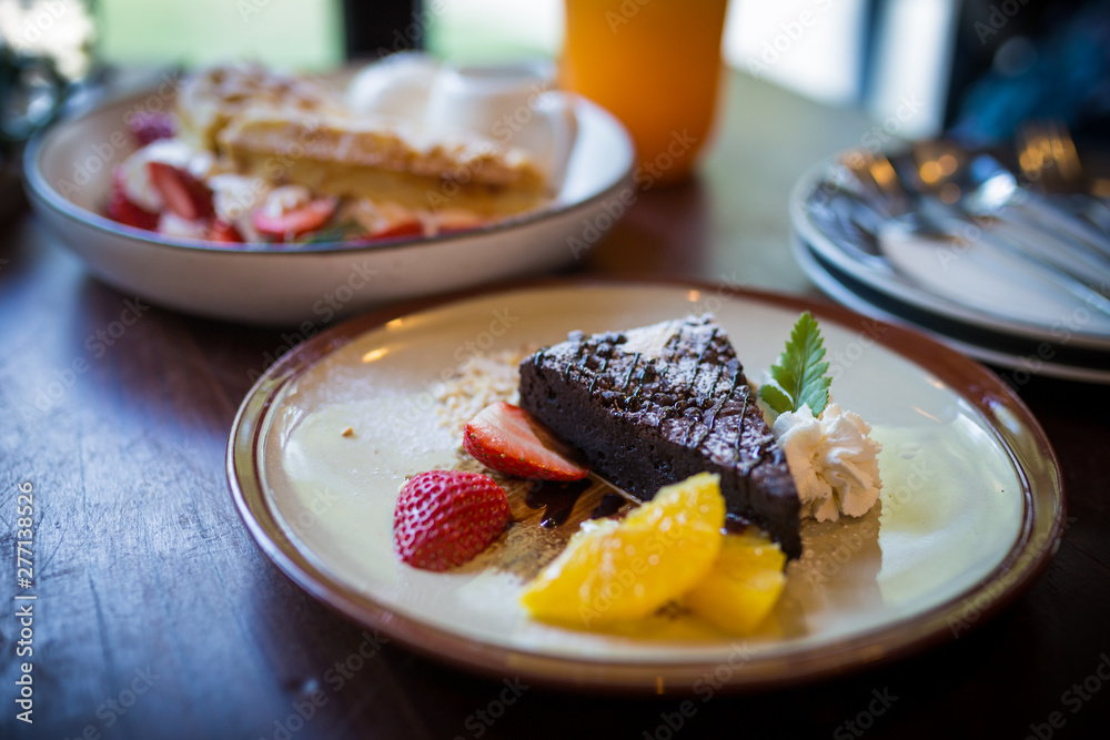 homemade dark chocolate brownies and strawberry and fresh orrange