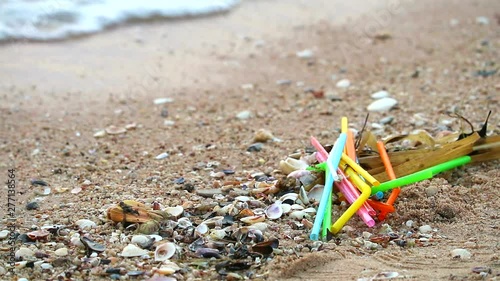 sunset on sea with many straw are left on the beach and the waves blew them into the sea1 photo