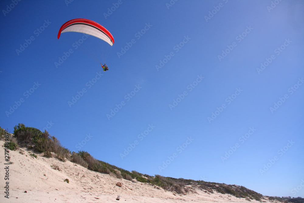 Paragliding over sand dunes