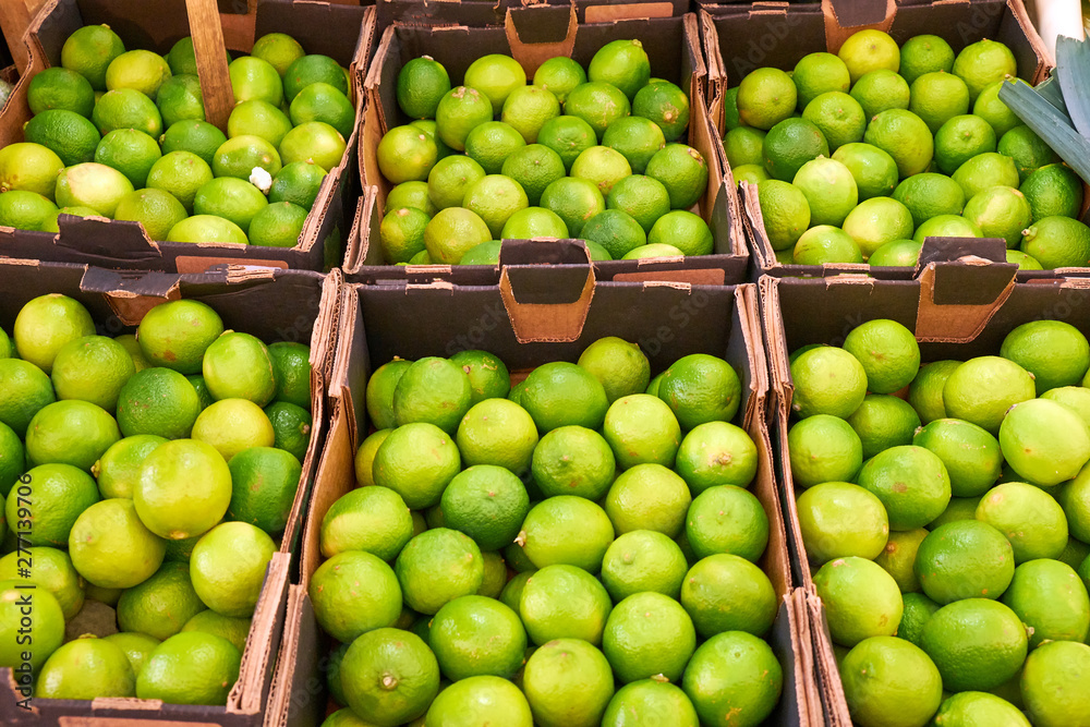 Fresh limes in boxes for sale at a market