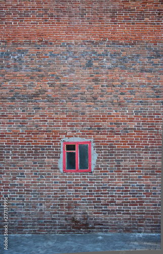 Old vintage grunge brick wall and small window