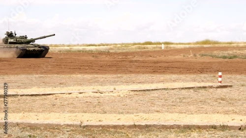 heavy tanks shoot guns and machine guns at combat positions