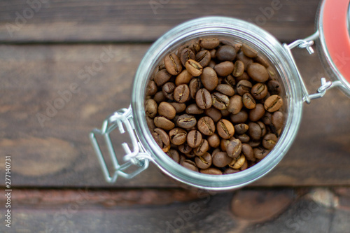 coffee beans in a glass cup on wooden table