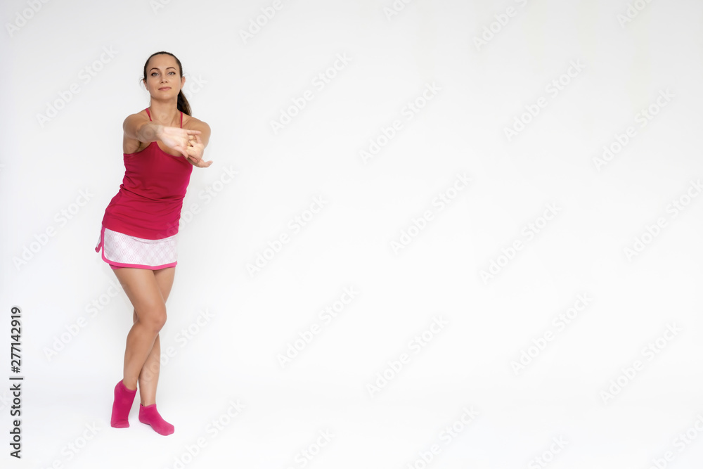 Full-length portrait on white background of beautiful pretty fitness girl woman in pink sport uniform standing exercises in different poses with different emotions. Smiles Stylish trendy youth. Full-length portrait on white background of beautiful pretty fitness girl woman in pink sport uniform standing exercises in different poses with different emotions. Smiles Stylish trendy youth.