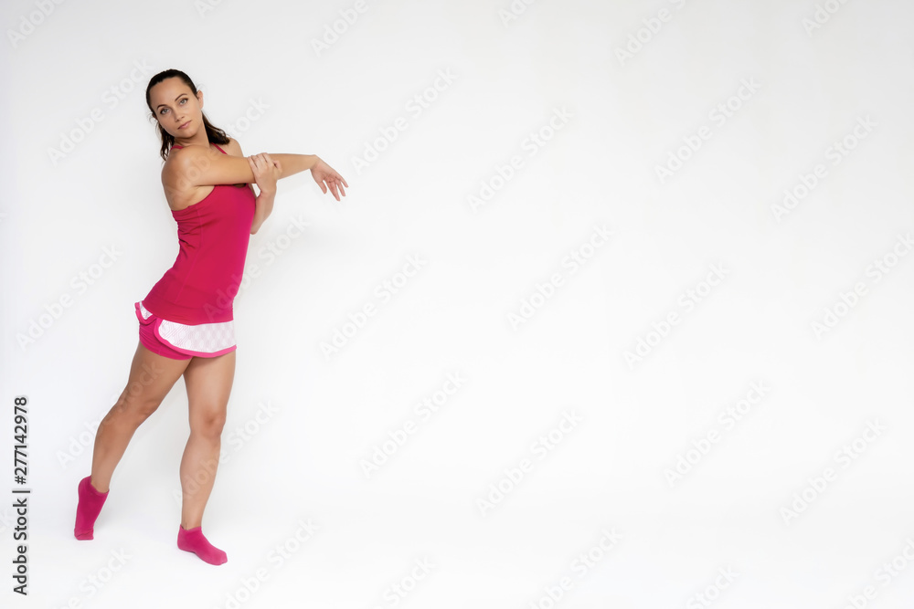 Full-length portrait on white background of beautiful pretty fitness girl woman in pink sport uniform standing exercises in different poses with different emotions. Smiles Stylish trendy youth. Full-length portrait on white background of beautiful pretty fitness girl woman in pink sport uniform standing exercises in different poses with different emotions. Smiles Stylish trendy youth.