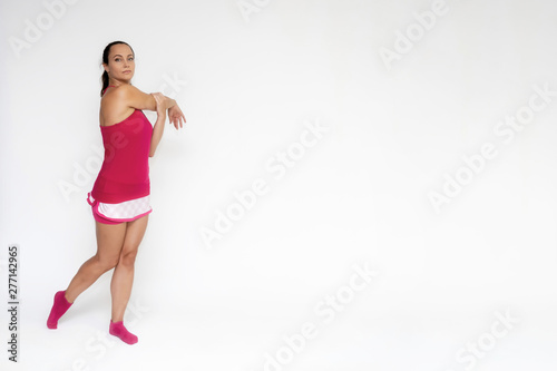 Full-length portrait on white background of beautiful pretty fitness girl woman in pink sport uniform standing exercises in different poses with different emotions. Smiles Stylish trendy youth.