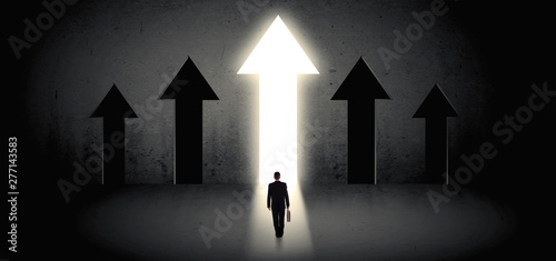Young businessman with back choosing the best way