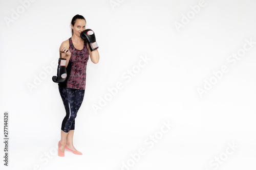 Full-length portrait on white background of beautiful pretty fitness woman girl in fashionable sportswear standing exercising in different poses with boxing gloves. Smiles Stylish trendy youth. photo