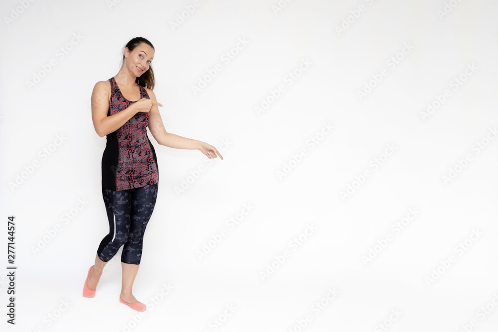 Full-length portrait on white background of beautiful pretty fitness woman girl in fashionable sportswear standing exercising in different poses, showing hands. Smiles Stylish trendy youth.