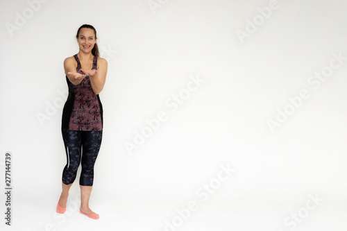 Full-length portrait on white background of beautiful pretty fitness woman girl in fashionable sportswear standing exercising in different poses, showing hands. Smiles Stylish trendy youth.