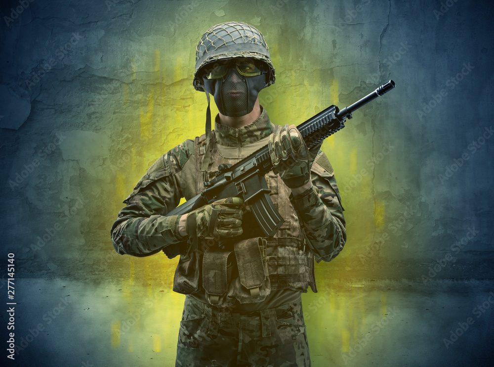 Hazard, menace soldier in a ruined crumbly building with arms on his hand Hazard, menace soldier in a ruined crumbly building with arms on his hand