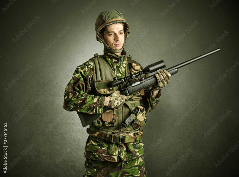 Soldier agent in a dark room with arms on his hand and gas mask Soldier agent in a dark room with arms on his hand and gas mask
