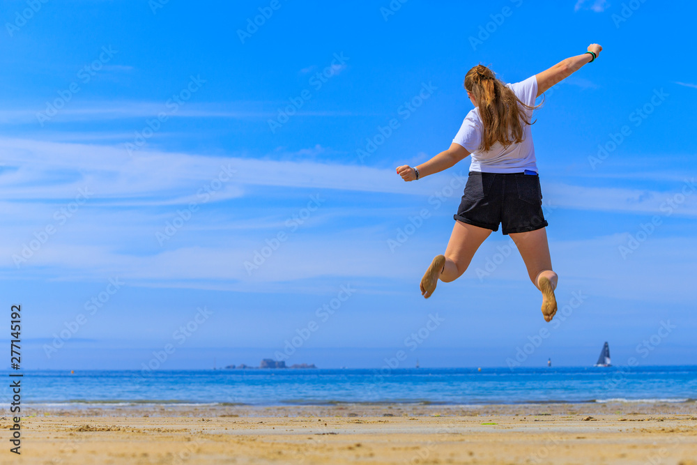 girl jumping on the beach
