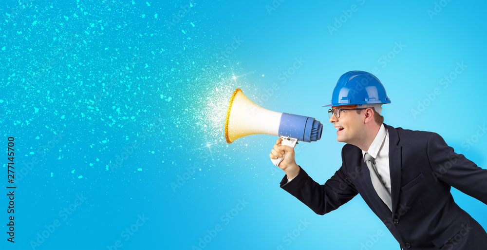 Fototapeta premium Young architect constructor yelling with megaphone and sparkling sounds