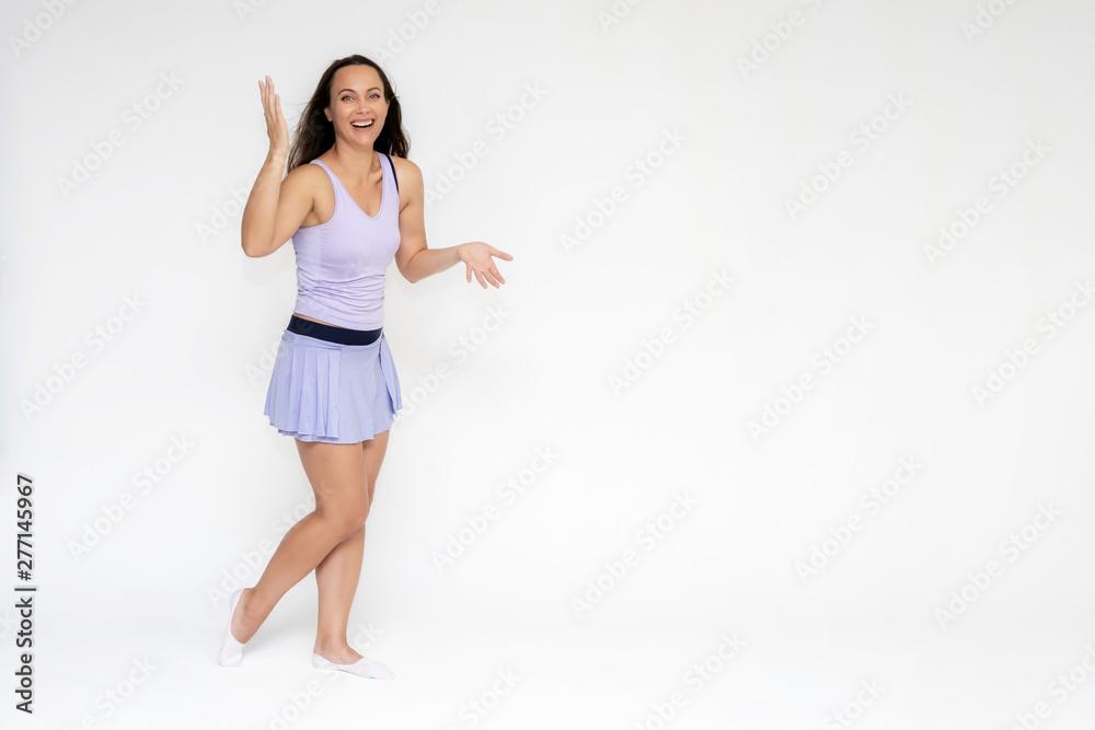 Full-length portrait on white background of beautiful pretty fitness girl woman in trendy tennis sport uniform, with different emotions in different poses, shows hands. Smiles. Stylish trendy youth. Full-length portrait on white background of beautiful pretty fitness girl woman in trendy tennis sport uniform, with different emotions in different poses, shows hands. Smiles. Stylish trendy youth.