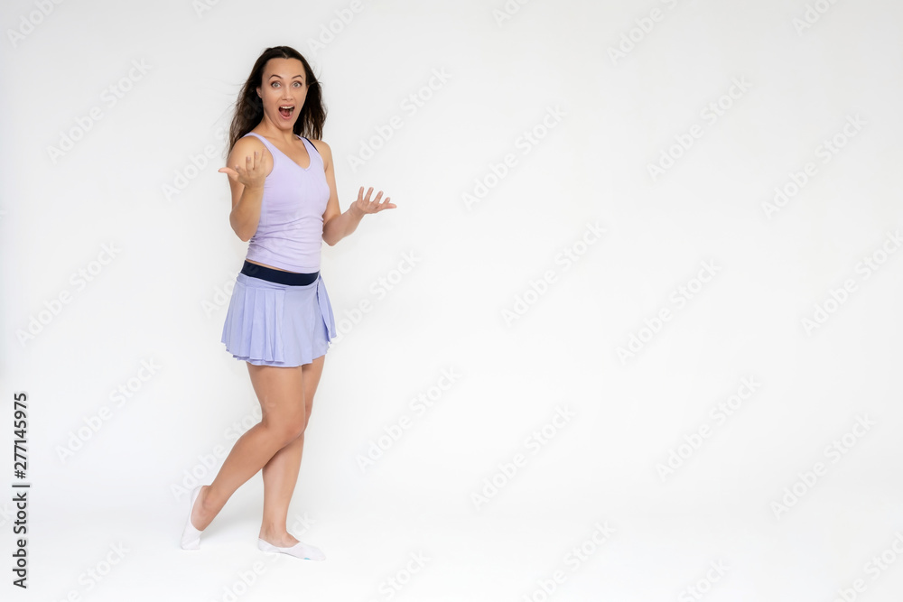 Full-length portrait on white background of beautiful pretty fitness girl woman in trendy tennis sport uniform, with different emotions in different poses, shows hands. Smiles. Stylish trendy youth. Full-length portrait on white background of beautiful pretty fitness girl woman in trendy tennis sport uniform, with different emotions in different poses, shows hands. Smiles. Stylish trendy youth.