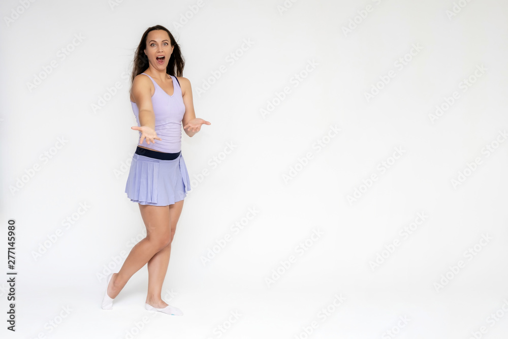 Full-length portrait on white background of beautiful pretty fitness girl woman in trendy tennis sport uniform, with different emotions in different poses, shows hands. Smiles. Stylish trendy youth. Full-length portrait on white background of beautiful pretty fitness girl woman in trendy tennis sport uniform, with different emotions in different poses, shows hands. Smiles. Stylish trendy youth.