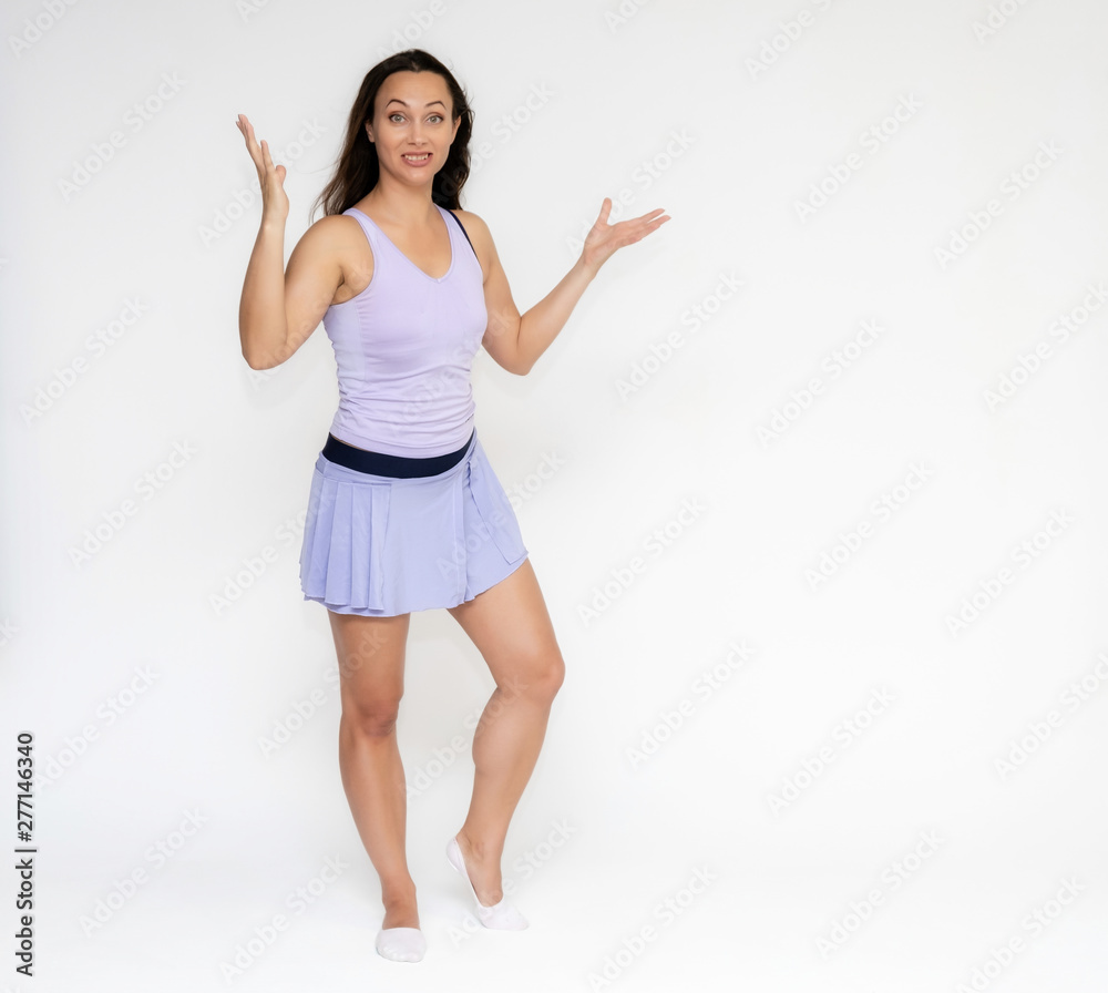 Full-length portrait on white background of beautiful pretty fitness girl woman in trendy tennis sport uniform, with different emotions in different poses, shows hands. Smiles. Stylish trendy youth. Full-length portrait on white background of beautiful pretty fitness girl woman in trendy tennis sport uniform, with different emotions in different poses, shows hands. Smiles. Stylish trendy youth.