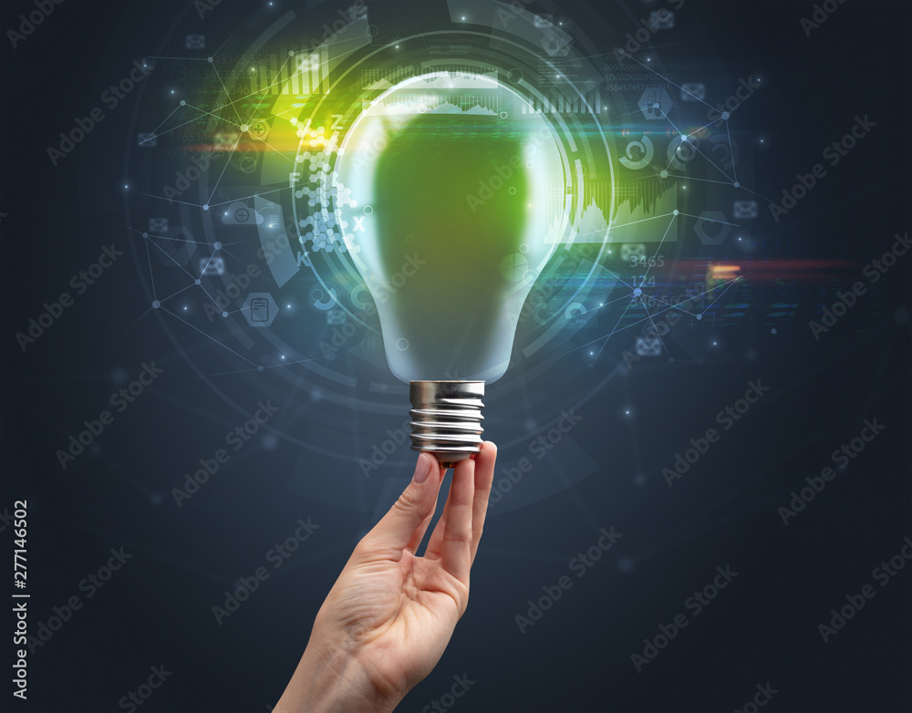 Hand holding light bulb on dark background. New business idea concept Hand holding light bulb on dark background. New business idea concept