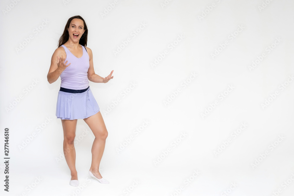 Full-length portrait on white background of beautiful pretty fitness girl woman in trendy tennis sport uniform, with different emotions in different poses, shows hands. Smiles. Stylish trendy youth. Full-length portrait on white background of beautiful pretty fitness girl woman in trendy tennis sport uniform, with different emotions in different poses, shows hands. Smiles. Stylish trendy youth.