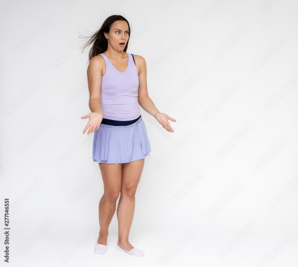 Full-length portrait on white background of beautiful pretty fitness girl woman in trendy tennis sport uniform, with different emotions in different poses, shows hands. Smiles. Stylish trendy youth. Full-length portrait on white background of beautiful pretty fitness girl woman in trendy tennis sport uniform, with different emotions in different poses, shows hands. Smiles. Stylish trendy youth.