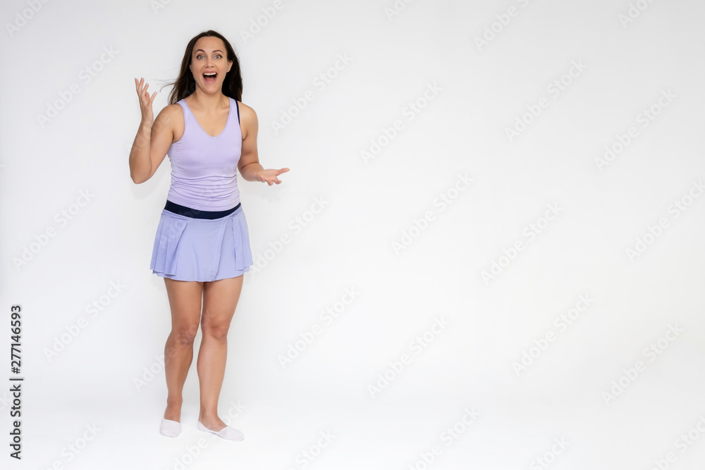 Full-length portrait on white background of beautiful pretty fitness girl woman in trendy tennis sport uniform, with different emotions in different poses, shows hands. Smiles. Stylish trendy youth. Full-length portrait on white background of beautiful pretty fitness girl woman in trendy tennis sport uniform, with different emotions in different poses, shows hands. Smiles. Stylish trendy youth.