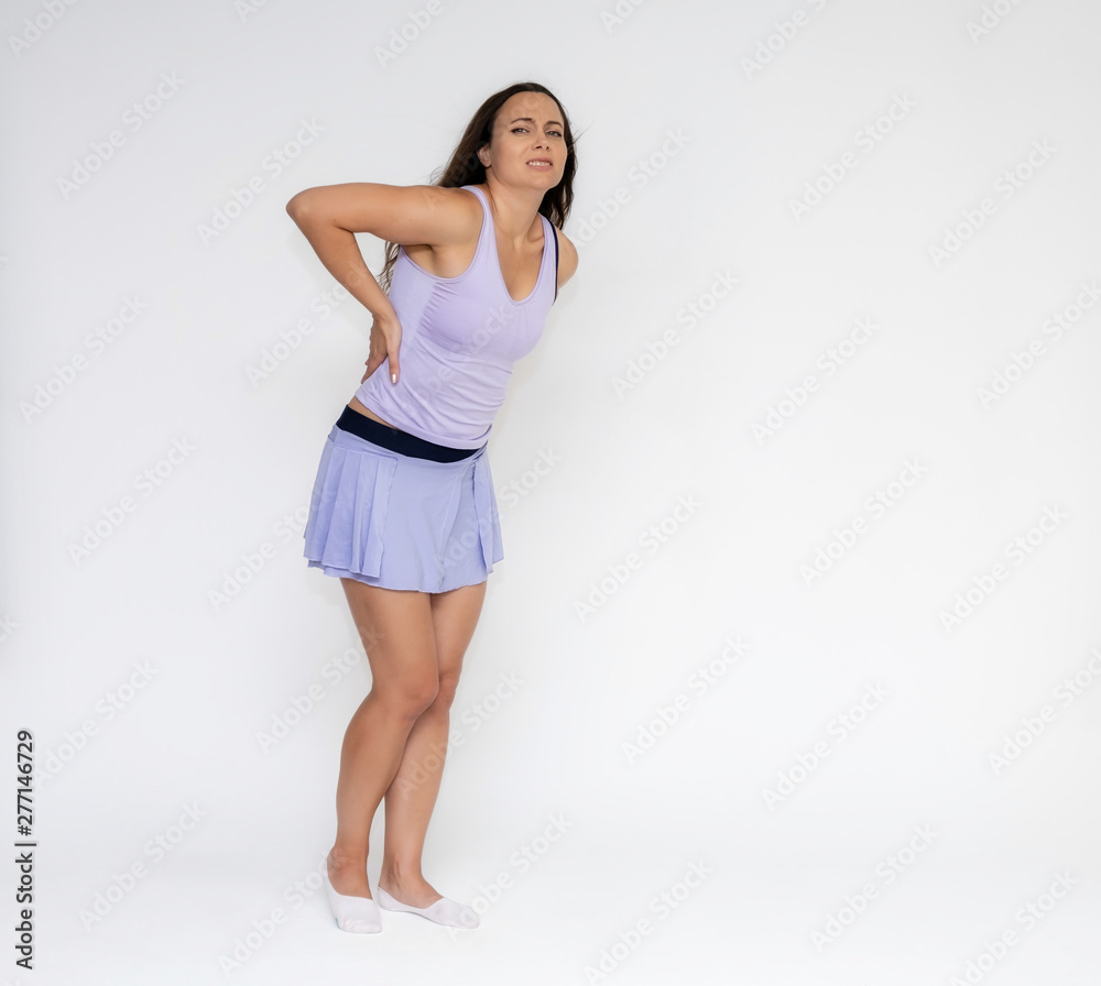 Full-length portrait on white background of beautiful pretty fitness girl woman in fashionable tennis sportswear, experiencing pain, injury in various poses, shows hands. Smiles Stylish trendy youth. Full-length portrait on white background of beautiful pretty fitness girl woman in fashionable tennis sportswear, experiencing pain, injury in various poses, shows hands. Smiles Stylish trendy youth.