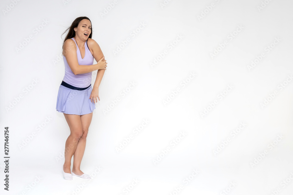 Full-length portrait on white background of beautiful pretty fitness girl woman in fashionable tennis sportswear, experiencing pain, injury in various poses, shows hands. Smiles Stylish trendy youth. Full-length portrait on white background of beautiful pretty fitness girl woman in fashionable tennis sportswear, experiencing pain, injury in various poses, shows hands. Smiles Stylish trendy youth.