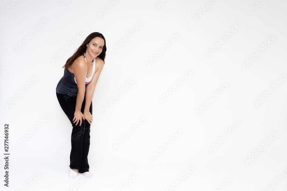 Full-length portrait on white background of beautiful pretty fitness girl woman in sports uniform, standing with different emotions in different poses, showing hands. Smiles Stylish trendy youth. Full-length portrait on white background of beautiful pretty fitness girl woman in sports uniform, standing with different emotions in different poses, showing hands. Smiles Stylish trendy youth.