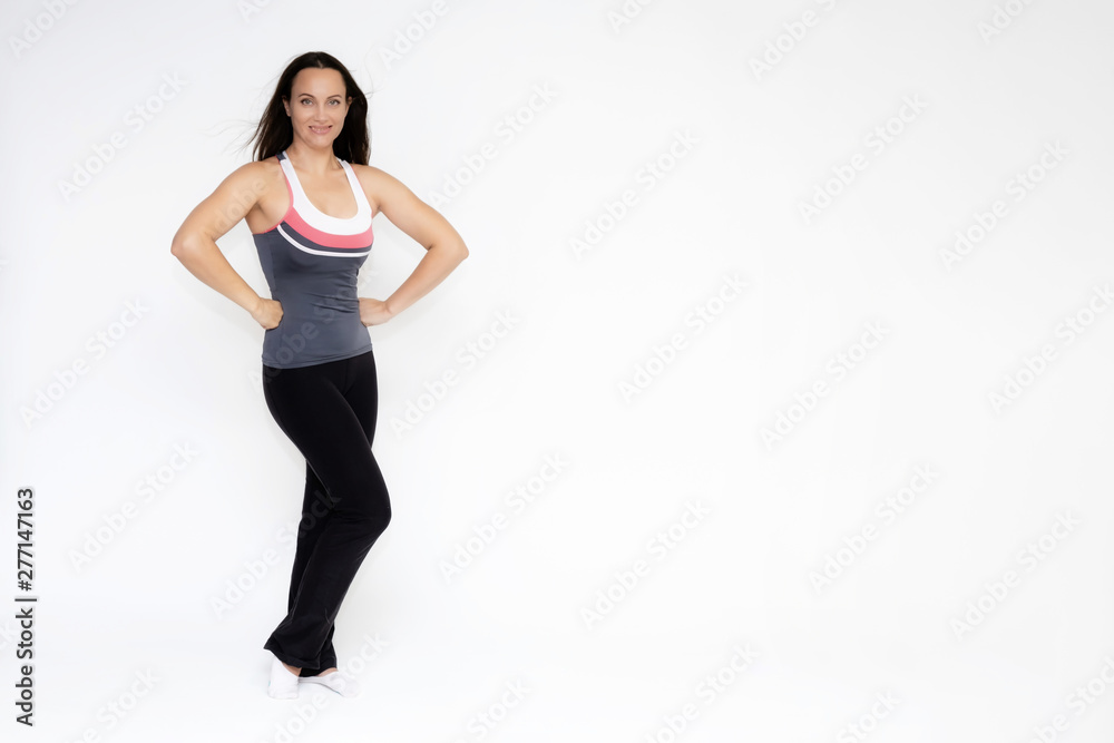 Full-length portrait on white background of beautiful pretty fitness girl woman in sports uniform, standing with different emotions in different poses, showing hands. Smiles Stylish trendy youth. Full-length portrait on white background of beautiful pretty fitness girl woman in sports uniform, standing with different emotions in different poses, showing hands. Smiles Stylish trendy youth.