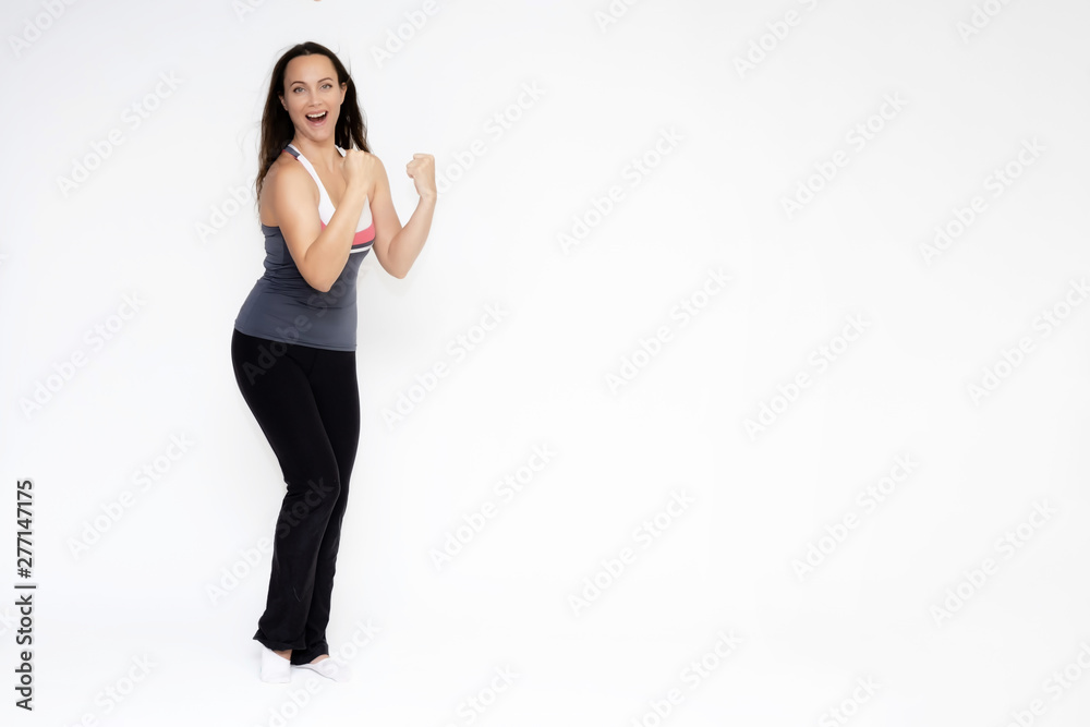 Full-length portrait on white background of beautiful pretty fitness girl woman in sports uniform, standing with different emotions in different poses, showing hands. Smiles Stylish trendy youth. Full-length portrait on white background of beautiful pretty fitness girl woman in sports uniform, standing with different emotions in different poses, showing hands. Smiles Stylish trendy youth.