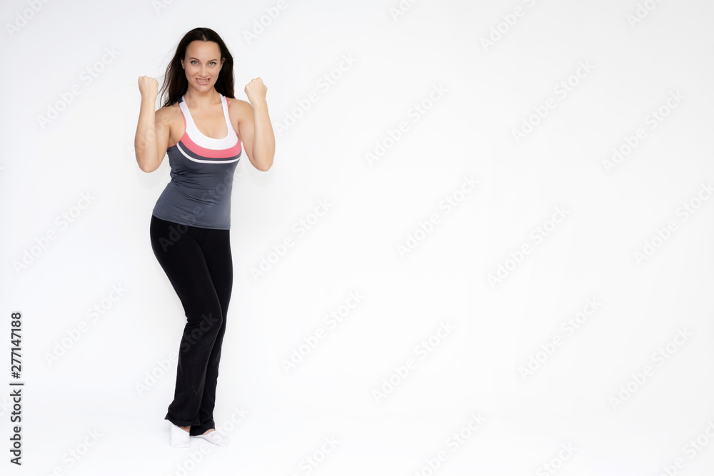 Full-length portrait on white background of beautiful pretty fitness girl woman in sports uniform, standing with different emotions in different poses, showing hands. Smiles Stylish trendy youth. Full-length portrait on white background of beautiful pretty fitness girl woman in sports uniform, standing with different emotions in different poses, showing hands. Smiles Stylish trendy youth.