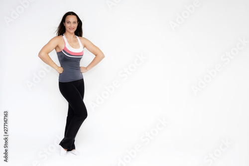 Full-length portrait on white background of beautiful pretty fitness girl woman in sports uniform, standing with different emotions in different poses, showing hands. Smiles Stylish trendy youth.