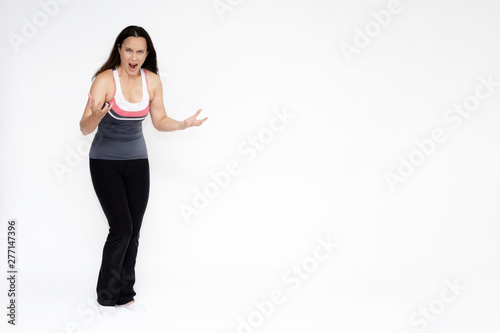 Full-length portrait on white background of beautiful pretty fitness girl woman in sports uniform, sitting on the stairs with different emotions in different poses. Stylish trendy youth.